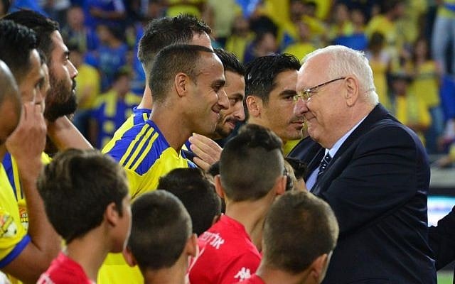 President Reuven Rivlin congratulates members of the Maccabi Tel Aviv Football Club after their victory in the Israeli state cup final against Hapoel Beersheba, at the Sammy Ofer Stadium in Haifa on May 20, 2015. (Kobi Gideon/GPO) President Reuven Rivlin congratulates members of the Maccabi Tel Aviv Football Club after their victory in the Israeli state cup final against Hapoel Beersheba, at the Sammy Ofer Stadium in Haifa on May 20, 2015. (Kobi Gideon/GPO)