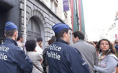 Police protecting participants at a silent vigil on May 25, 2014 outside Brussels’ Jewish museum. (Cnaan Liphshiz/JTA)