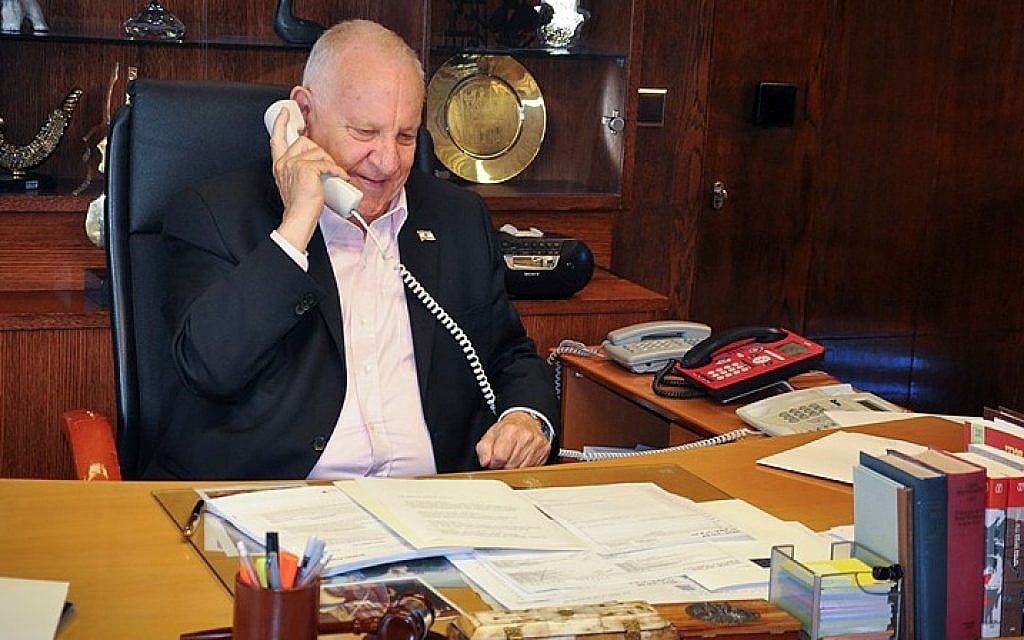 President Reuven Rivlin makes a phone call to a team of Israeli soldiers a week after they were were sent to Nepal following a deadly earthquake, May 7, 2015. (photo credit: GPO)