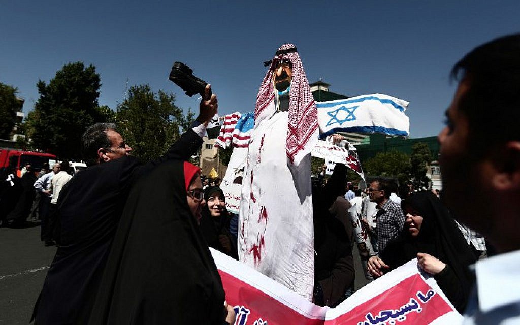 An Iranian man beats with his shoe an effigy of a Saudi royal with flags of the United States and Israel attached to it during a demonstration in Tehran on May 8, 2015. (photo credit: AFP/Behrouz Mehri) An Iranian man beats with his shoe an effigy of a Saudi royal with flags of the United States and Israel attached to it during a demonstration in Tehran on May 8, 2015. (photo credit: AFP/Behrouz Mehri)