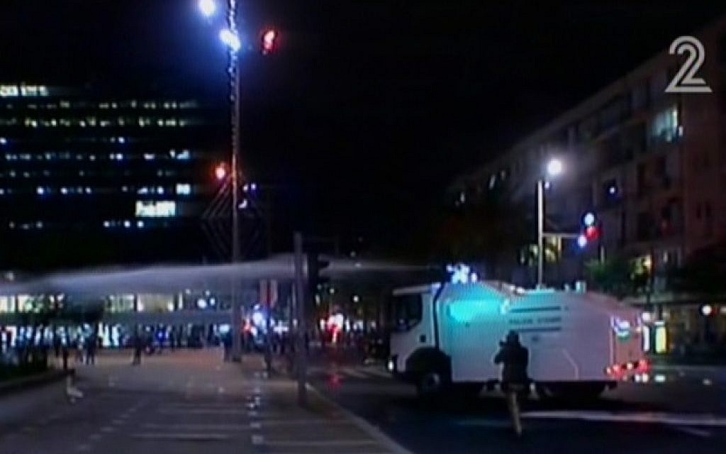A truck spraying so-called 'skunk water' at protesters to break up a rally in Tel Aviv on May 3, 2015. (screen capture: Channel 2)