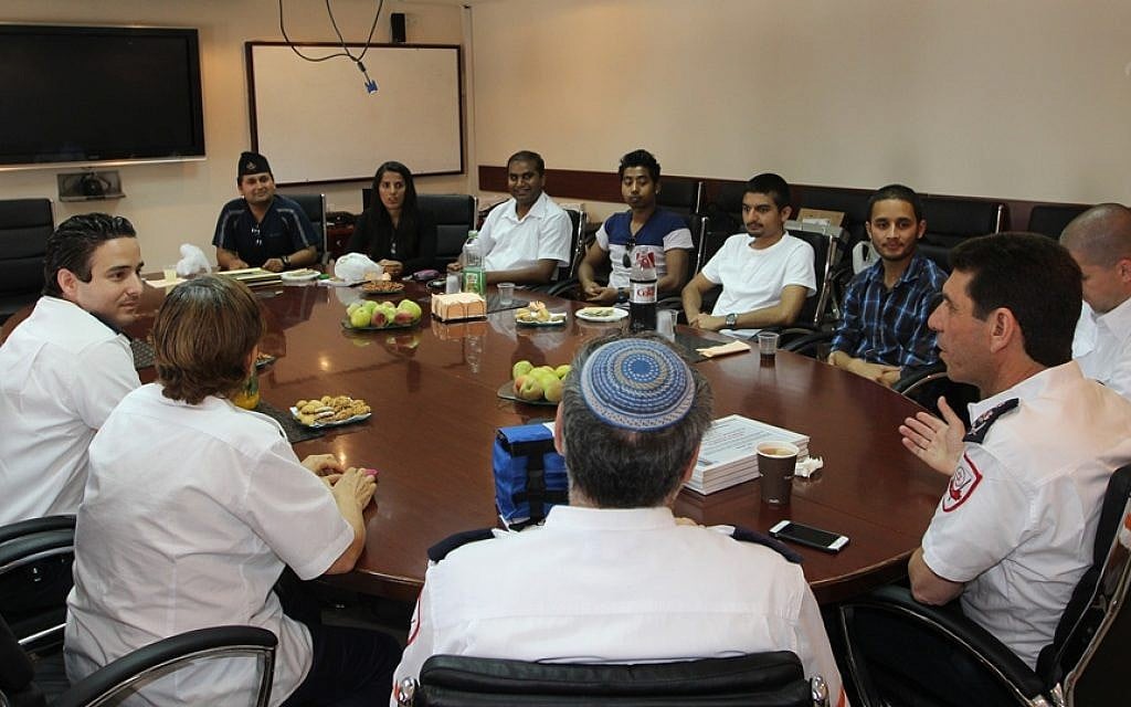 Nepalese students having a discussion with Magen David Adom paramedics and organization head Eli Bin after receiving diplomas of recognition from the organization. (Photo credit: Magen David Adom) Nepalese students having a discussion with Magen David Adom paramedics and organization head Eli Bin after receiving diplomas of recognition from the organization. (Photo credit: Magen David Adom)