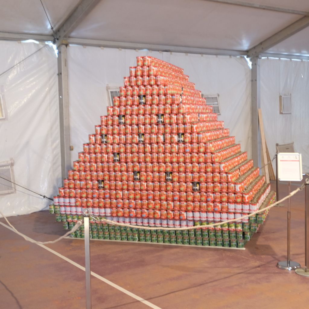 A pyramid of cans stacked into a slice of watermelon, at Leket's Canstruction exhibit (Courtesy Leket Israel)