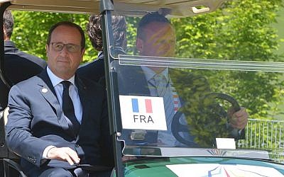 France's President Francois Hollande arrives in a golf cart at the Elmau Castle resort near Garmisch-Partenkirchen on June 7, 2015 at the start of a G7 Summit (AFP PHOTO / MANDEL NGAN)