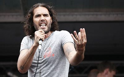 British comedian Russell Brand speaks to protesters following a march against the British government's spending cuts and austerity measures in London on June 20, 2015 (AFP PHOTO / JUSTIN TALLIS) British comedian Russell Brand speaks to protesters following a march against the British government's spending cuts and austerity measures in London on June 20, 2015 (AFP PHOTO / JUSTIN TALLIS)