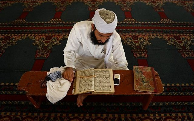 A Pakistani Muslim man recites the Quran at a mosque ahead of Ramadan in Peshawar on June 18, 2015. AFP PHOTO/ A MAJEED A Pakistani Muslim man recites the Quran at a mosque ahead of Ramadan in Peshawar on June 18, 2015. AFP PHOTO/ A MAJEED
