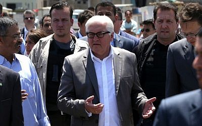 German Foreign Minister Frank-Walter Steinmeier, center, gestures during a visit to the sea port in Gaza City, June 1, 2015. (AFP/MAHMUD HAMS)