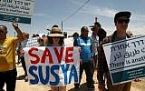 Palestinians, foreigners and Israeli peace activists demonstrate in the southern West Bank village of Sussiya against the demolition of the Palestinian village in the Hebron Hills, on June 5, 2015. (AFP/Hazem Bader)