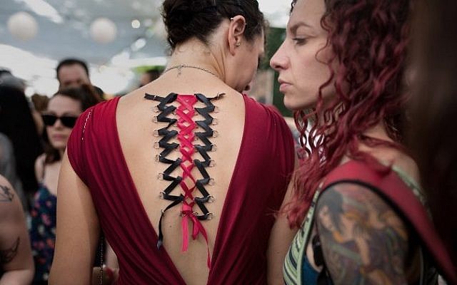 A woman with piercings in her back takes part in the three-day annual tattoo festival on June 6, 2015 in Tel Aviv (Menahem Kahana/AFP)
