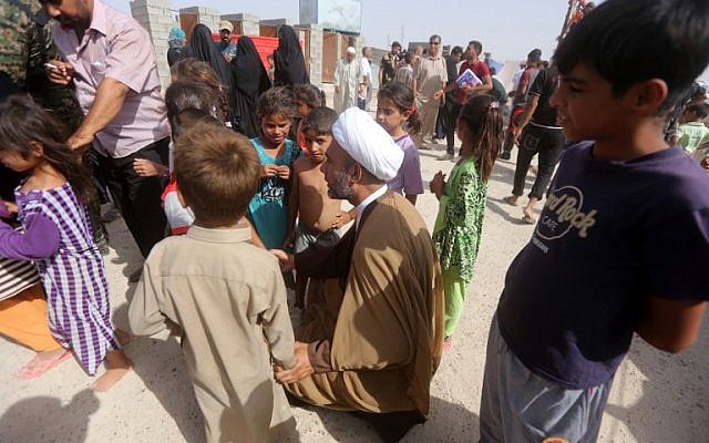 A representative of Iraq's Shiite spiritual leader talks with displaced Iraqi children who fled Ramadi, after it was seized by the Islamic State, at a makeshift camp for internally displaced persons in Ameriyat al-Fallujah, June 6, 2015. (AFP/Ahmad al-Rubaye) A representative of Iraq's Shiite spiritual leader talks with displaced Iraqi children who fled Ramadi, after it was seized by the Islamic State, at a makeshift camp for internally displaced persons in Ameriyat al-Fallujah, June 6, 2015. (AFP/Ahmad al-Rubaye)