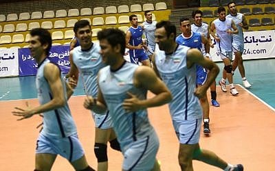 A file picture taken on July 8, 2014, shows Iran's volleyball national team players warming up during a training session at Azadi sports hall in Tehran.  (AFP PHOTO / BEHROUZ MEHRI)