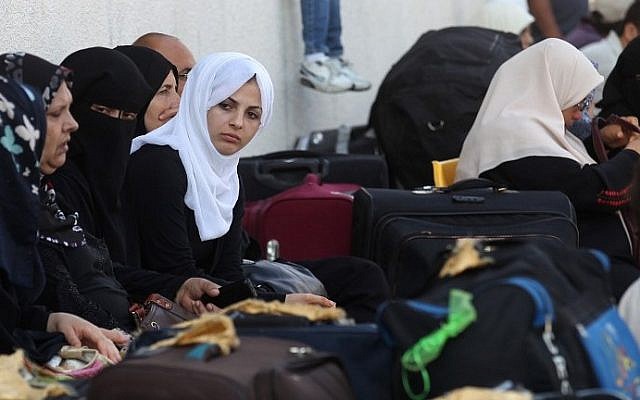 Palestinian women wait with their luggage to cross into Egypt at the Rafah Border Crossing in the southern Gaza Strip on June 23, 2015. (Said Khatib/AFP) Palestinian women wait with their luggage to cross into Egypt at the Rafah Border Crossing in the southern Gaza Strip on June 23, 2015. (Said Khatib/AFP)