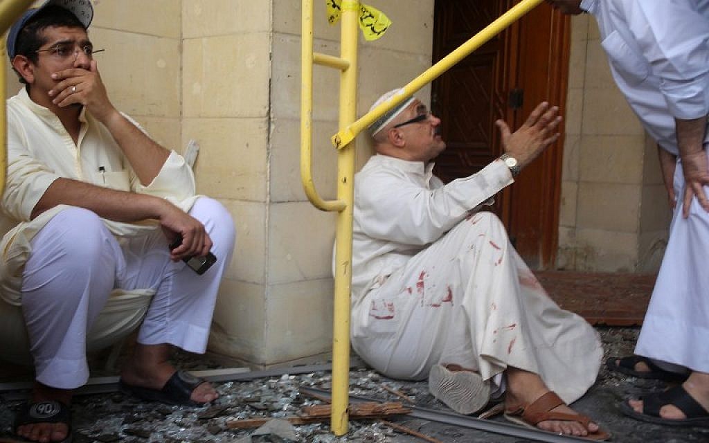 Kuwaiti men react at the site of a suicide bombing that targeted the Shiite Al-Imam al-Sadeq mosque during Friday prayers on June 26, 2015, in Kuwait City. (AFP PHOTO / YASSER AL-ZAYYAT)