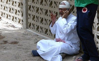 A Kuwaiti man with blood-stained clothes and a bandaged head uses a phone at the site of a suicide bombing that targeted the Shi'ite Al-Imam al-Sadeq mosque after it was targeted by a suicide bombing during Friday prayers on June 26, 2015, in Kuwait City. (AFP PHOTO / STR) A Kuwaiti man with blood-stained clothes and a bandaged head uses a phone at the site of a suicide bombing at the Shi'ite Al-Imam al-Sadeq mosque during Friday prayers on June 26, 2015, in Kuwait City. (AFP PHOTO / STR)
