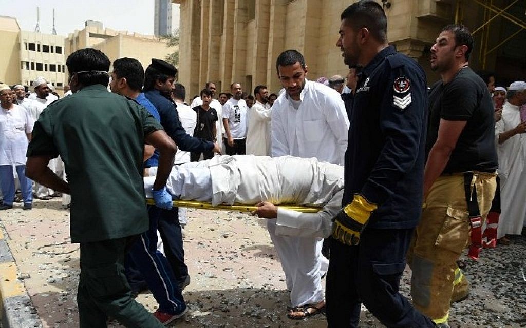 Kuwaiti security personnel and medical staff carry a man on a stretcher at the site of a suicide bombing that targeted the Shiite Al-Imam al-Sadeq mosque after it was targeted by a suicide bombing during Friday prayers on June 26, 2015, in Kuwait City. (AFP PHOTO / STR)