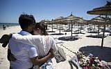People react at the site of a shooting attack on the beach in front of the Riu Imperial Marhaba Hotel in Port el Kantaoui, on the outskirts of Sousse south of the capital Tunis, on June 27, 2015. (AFP/KENZO TRIBOUILLARD)