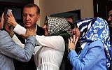 An election official (C) takes a selfie photo with Turkish President Recep Tayyip Erdogan (L) after he cast his ballot in Turkey's legislative election in Istanbul on June 7, 2015. (AFP PHOTO / OZAN KOSE)