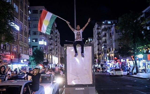 Supporters of pro-Kurdish Peoples' Democratic Party (HDP) celebrate in the streets of Diyarbakir following the results of the Turkish legislative elections on June 7, 2015. (AFP/BULENT KILIC)
