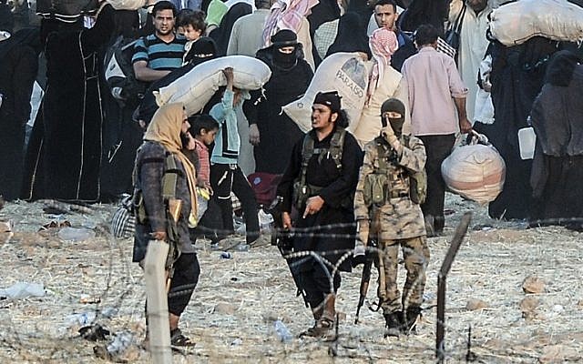 Islamic State members ask people to go back to city center at the Turkish Akcakale crossing gate in Sanliurfa province, on June 13, 2015.(AFP PHOTO / BULENT KILIC)
