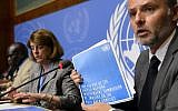 Information Officer for the Office of the High Commissioner for Human Rights Rolando Gomez holds the report of the Commission of Inquiry on the 2014 Gaza conflict next to Commission chairperson Mary McGowan Davis, center, and Commission member Doudou Diene during a press conference on their report on June 22, 2015 at the United Nations Office in Geneva. (AFP / FABRICE COFFRINI)