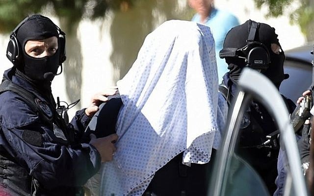 French police escort Yassin Salhi, a man suspected of decapitating his boss in an attack on a gas factory, as they leave his flat in Saint-Priest on June 28, 2015. (AFP/ PHILIPPE DESMAZES) French police escort Yassin Salhi, a man suspected of decapitating his boss in an attack on a gas factory, as they leave his flat in Saint-Priest on June 28, 2015. (AFP/ PHILIPPE DESMAZES)
