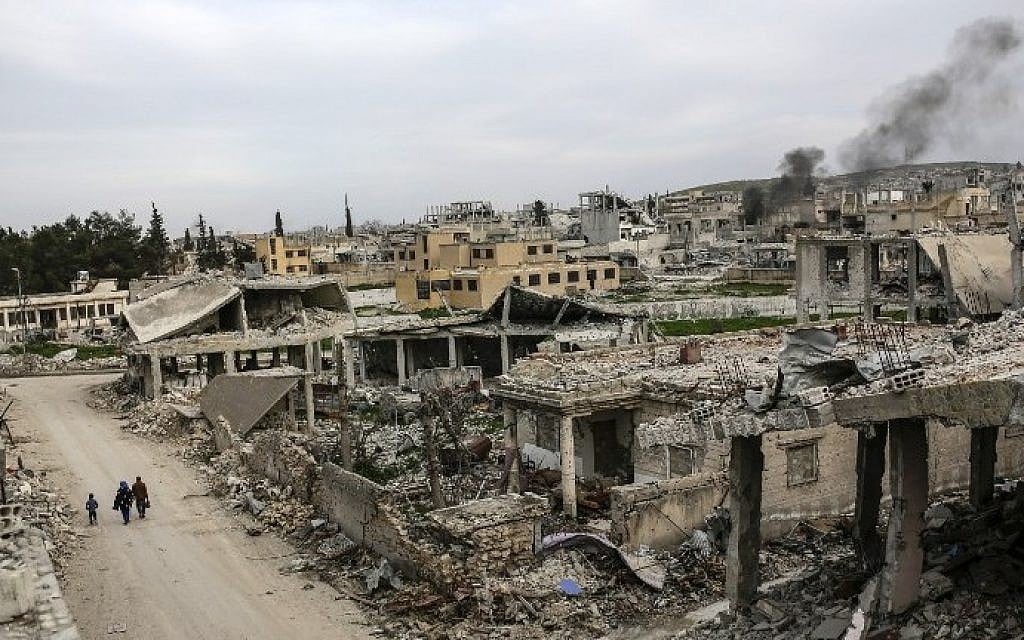 People walking along a conflict damaged street in the Syrian town of Kobane, March 27, 2015. Islamic State group fighters reentered the battleground town on June 25, 2015. (AFP/YASIN AKGUL) People walking along a conflict damaged street in the Syrian town of Kobane, March 27, 2015. Islamic State group fighters reentered the battleground town on June 25, 2015. (AFP/YASIN AKGUL)