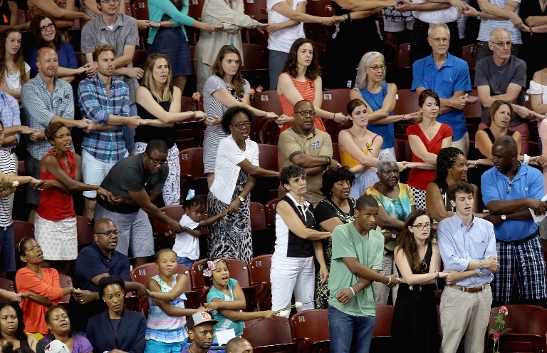 Thousands of people hold hands and sing 'We Shall Overcome' during a prayer vigil for the nine victims of the Emanuel AME Church shooting at the College of Charleston TD Arena June 19, 2015 in Charleston, South Carolina (Chip Somodevilla/Getty Images/AFP) Thousands of people hold hands and sing 'We Shall Overcome' during a prayer vigil for the nine victims of the Emanuel AME Church shooting at the College of Charleston TD Arena June 19, 2015 in Charleston, South Carolina (Chip Somodevilla/Getty Images/AFP)