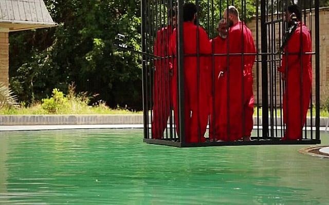 Islamic State jihadists lower five men into a pool to drown, in a video released June 23, 2015. (Screen capture) Islamic State jihadists lower five men into a pool to drown, in a video released June 23, 2015. (Screen capture)