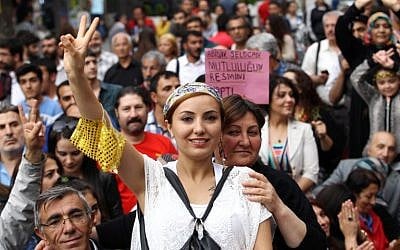A supporter of pro-Kurdish People's Democracy Party (HDP) makes a victory sign as she celebrates the results of the HDP party as part of the legislative election in Ankara, on June 9, 2015. (AFP photo/Adem Altan)