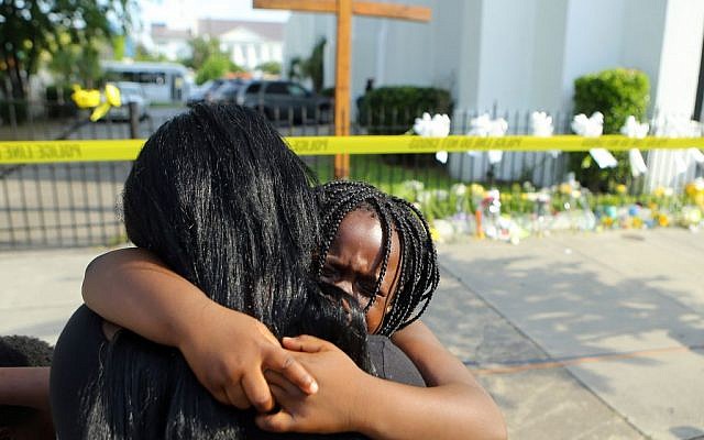 Kearston Farr hugs her 5-year-old daughter Taliyah visiting a memorial in front of the Emanuel AME Church on Friday, June 19, 2015 in Charleston, S.C. (Curtis Compton/Atlanta Journal-Constitution via AP) Kearston Farr hugs her 5-year-old daughter Taliyah visiting a memorial in front of the Emanuel AME Church on Friday, June 19, 2015 in Charleston, S.C. (Curtis Compton/Atlanta Journal-Constitution via AP)