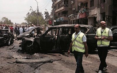 Emergency personnel inspect damage after a bomb attack targeted Egypt's state prosecutor in the Heliopolis district of Cairo, Egypt, June 29, 2015. (AP Photo/Ahmed Hatem)