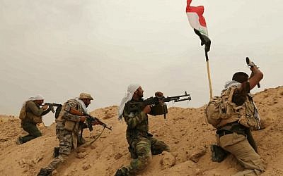 Fighters from the Badr Brigades Shiite militia clash with Islamic State fighters at the front line on the outskirts of Fallujah, Anbar province, Iraq, Monday, June 1, 2015. (AP Photo/Hadi Mizban)