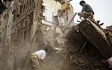A man searches for survivors under the rubble of houses destroyed by Saudi airstrikes in the old city of Sana'a, Yemen, June 12, 2015. (AP/Hani Mohammed)