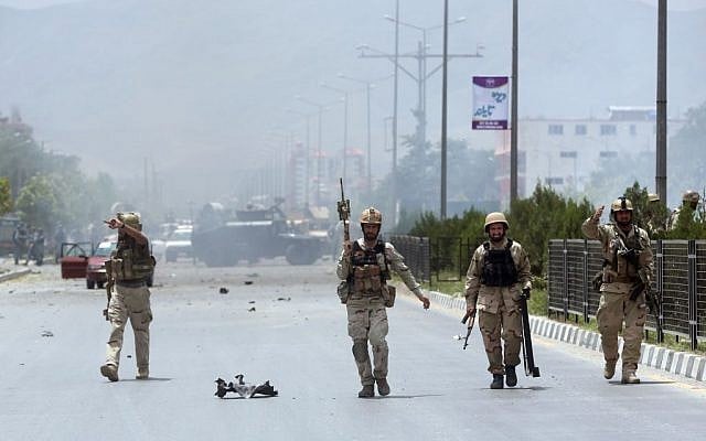 Afghan security forces inspect the site of a suicide attack during clashes with Taliban fighters in front of the Parliament, in Kabul, Afghanistan, Monday, June 22, 2015. (AP/ Massoud Hossaini)