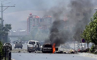 Fire and smokes rise at the site of a suicide attack during clashes with Taliban fighters in front of the Parliament, in Kabul, Afghanistan, Monday, June 22, 2015. (AP/Massoud Hossaini)