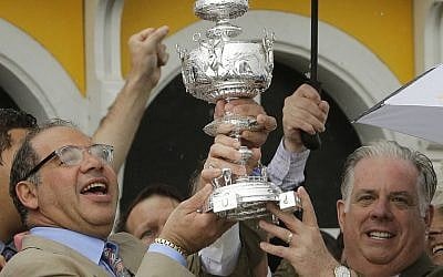 American Pharoah owner Ahmed Zayat, left, and Maryland Gov. Larry Hogan hold a replica of the Woodlawn Vase after American Pharoah won the 140th Preakness Stakes horse race at Pimlico Race Course in Baltimore, May 16, 2015. (AP/Matt Slocum, File)