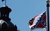 The Confederate flag flies near the South Carolina Statehouse, Friday, June 19, 2015, in Columbia, South Carolina (AP Photo/Rainier Ehrhardt)