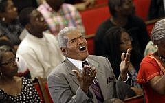 Parishioners sing at the Emanuel A.M.E. Church in Charleston, S.C. on Sunday, June 21, 2015, four days after a mass shooting that claimed the lives of it's pastor and eight others (AP Photo/David Goldman, Pool)