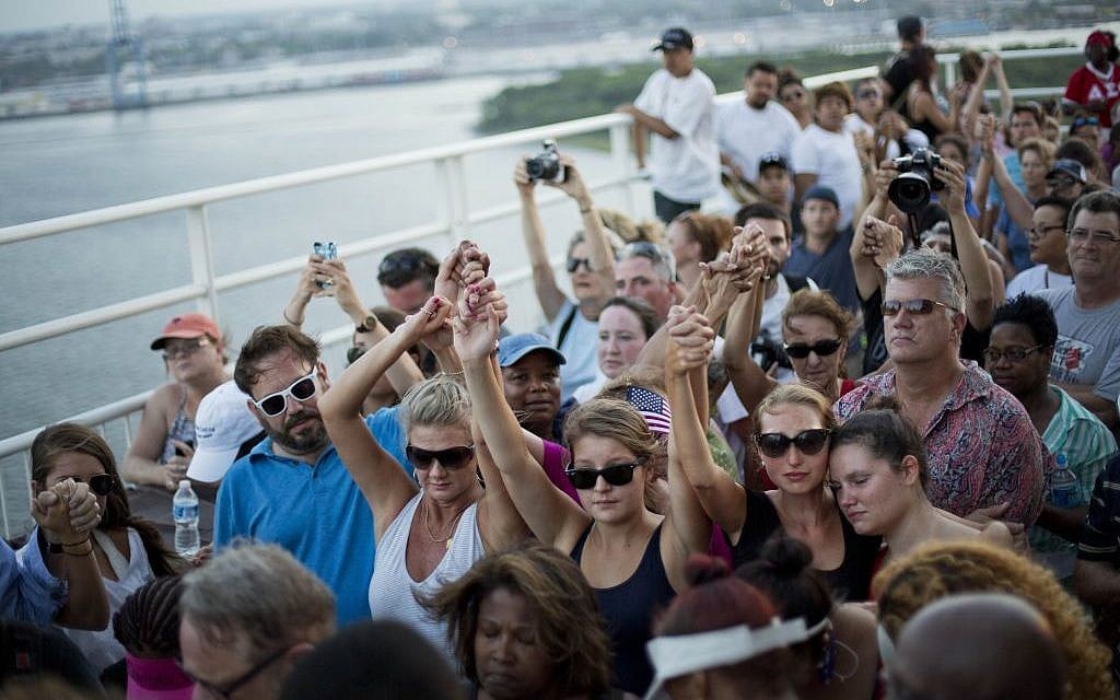 People join hands in a moment of silence as thousands of marchers meet on Charleston's main bridge in a show of unity after nine black church parishioners were gunned down during a Bible study, Sunday, June 21, 2015, in Charleston, S.C. (AP Photo/David Goldman) People join hands in a moment of silence as thousands of marchers meet on Charleston's main bridge in a show of unity after nine black church parishioners were gunned down during a Bible study, Sunday, June 21, 2015, in Charleston, S.C. (AP Photo/David Goldman)