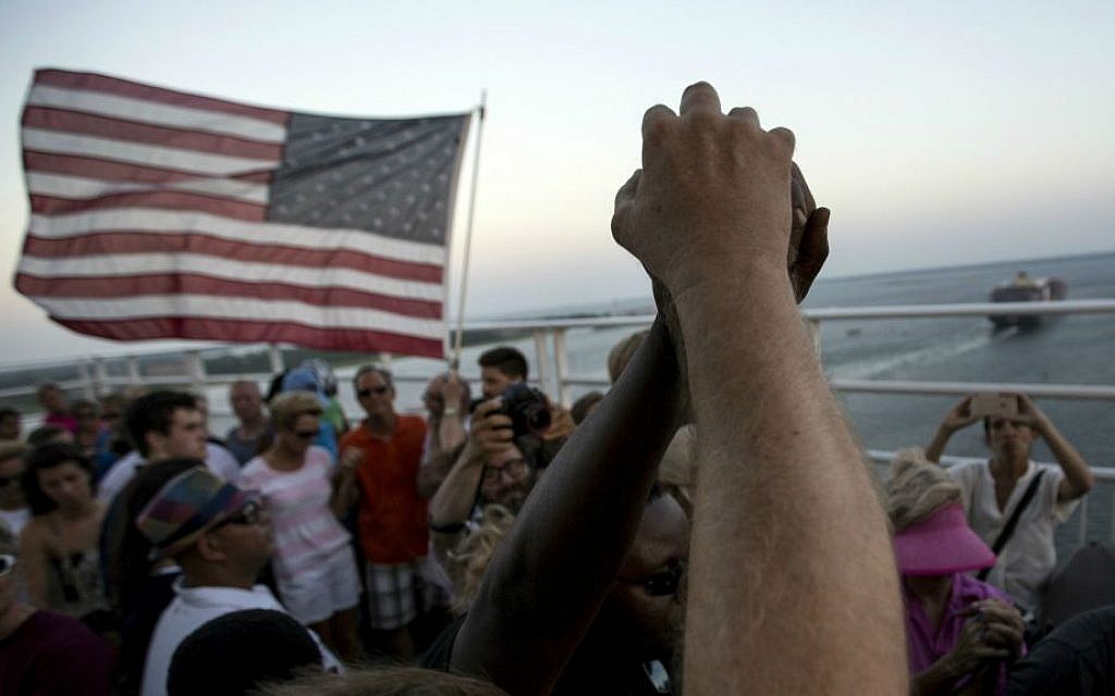 People raise their hands as a show of unity as thousands of marchers meet in the middle of Charleston's main bridge after nine black church parishioners were gunned down during a Bible study, Sunday, June 21, 2015, in Charleston, S.C. (AP Photo/Stephen B. Morton) People raise their hands as a show of unity as thousands of marchers meet in the middle of Charleston's main bridge after nine black church parishioners were gunned down during a Bible study, Sunday, June 21, 2015, in Charleston, S.C. (AP Photo/Stephen B. Morton)