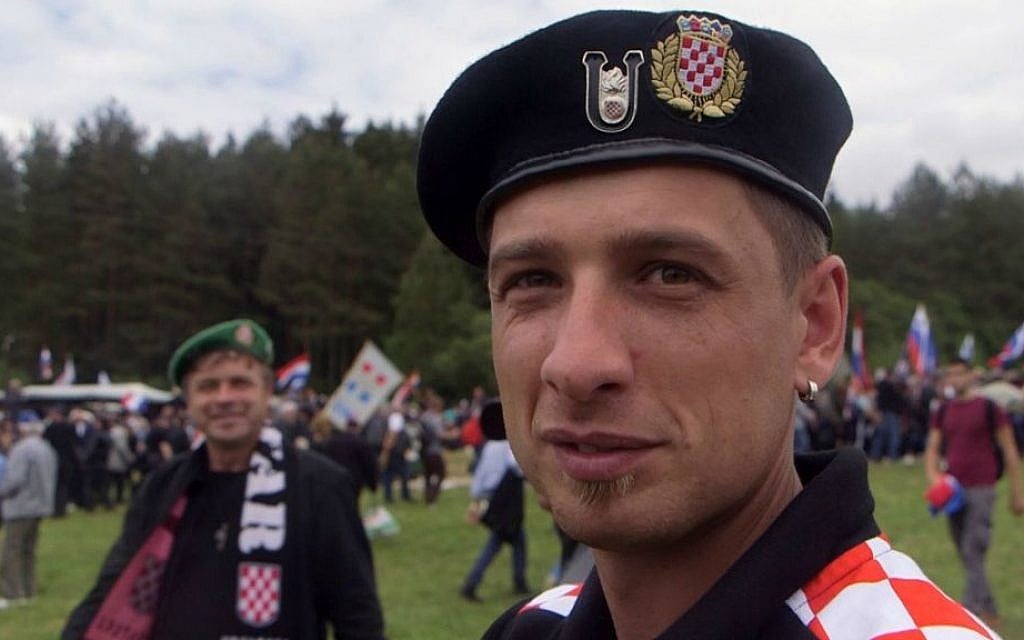 In this May 16, 2015 photo, a man from Croatia wearing WWII Croatian "Ustasha" insignia attends a memorial to the thousands of victims of the mass killings by Yugoslav communists, in Bleiburg, Austria. (AP Photo/Darko Bandic)