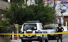 A police officer stands guard outside of the house where two tons of chemicals were found in the city of Larnaca, Cyprus, May 30, 2015. (Petros Karadjias/AP)