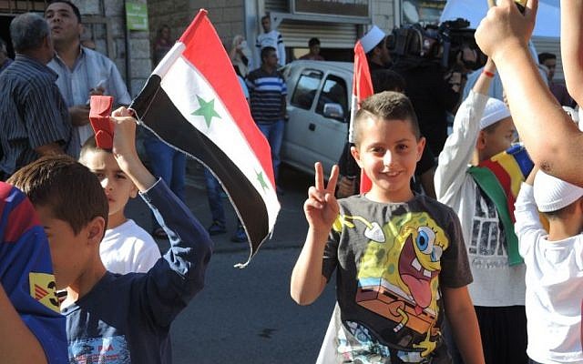 A Druze child at the pro-Assad protest in Majdal Shams on Monday. All of the Golan Heights Druze have family in Syria. (Melanie Lidman/Times of Israel)