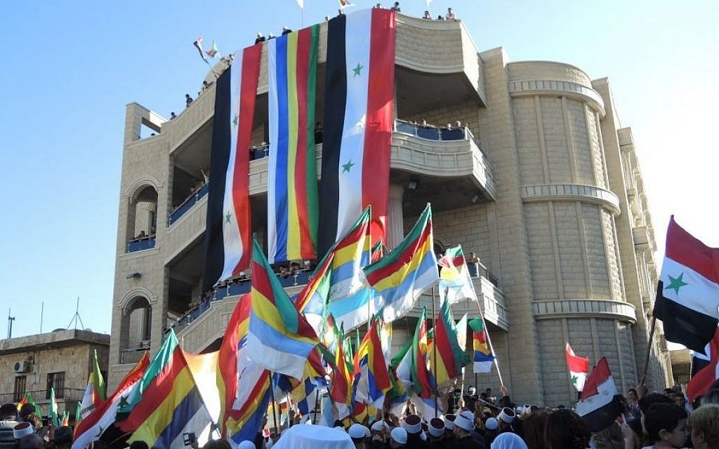 Syrian and Druze flags at a pro-Assad protest in the Druze village of Majdal Shams in the Golan Heights on Monday. (Melanie Lidman/Times of Israel) Syrian and Druze flags at a pro-Assad protest in the Druze village of Majdal Shams in the Golan Heights on Monday. (Melanie Lidman/Times of Israel)