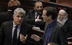 Yesh Atid's Yair Lapid (left) with Zionist Union's Isaac Herzog in the Knesset in 2013. (Photo by Miriam Alster/FLASH90)