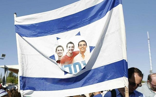 Israeli flag with the picture of the three murdered teens and the Hebrew word 'yachad' (united) seen at their joint funeral ceremony, in the Modiin cemetery, on July 1, 2014. (Yonatan Sindel/Flash90) Israeli flag with the picture of the three murdered teens and the Hebrew word 'yachad' (united) seen at their joint funeral ceremony, in the Modiin cemetery, on July 1, 2014. (Yonatan Sindel/Flash90)