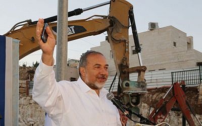 Avigdor Liberman speaks at a cornerstone laying ceremony for a new synagogue at his home settlement of Nokdim, October 23, 2014. Photo by Gershon Elinson/Flash90