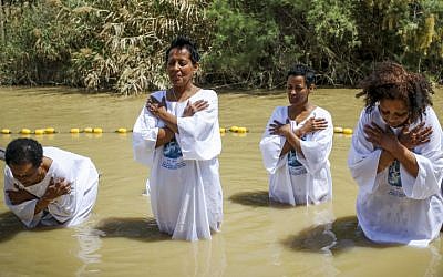 Women get baptized in the Jordan River during the Orthodox Easter celebrations on April 11, 2015. (Maxim Dinshtein/Flash90)