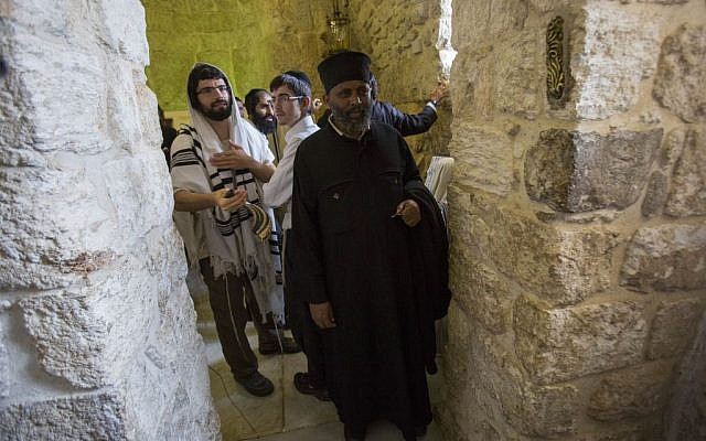 An Ethiopian Christian man poses for a picture alongside Orthodox Jewish worshipers at King David's Tomb, near Zion Gate in Jerusalem's Old City, on May 31, 2015 (Yonatan Sindel/Flash90) An Ethiopian Christian man poses for a picture alongside Orthodox Jewish worshipers at King David's Tomb, near Zion Gate in Jerusalem's Old City, on May 31, 2015 (Yonatan Sindel/Flash90)