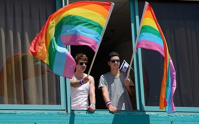 Men wave rainbow flags at the Annual Gay Pride Parade in Tel Aviv, June 12, 2015 (Flash90/Gili Yaari) Men wave rainbow flags at the Annual Gay Pride Parade in Tel Aviv, June 12, 2015 (Flash90/Gili Yaari)